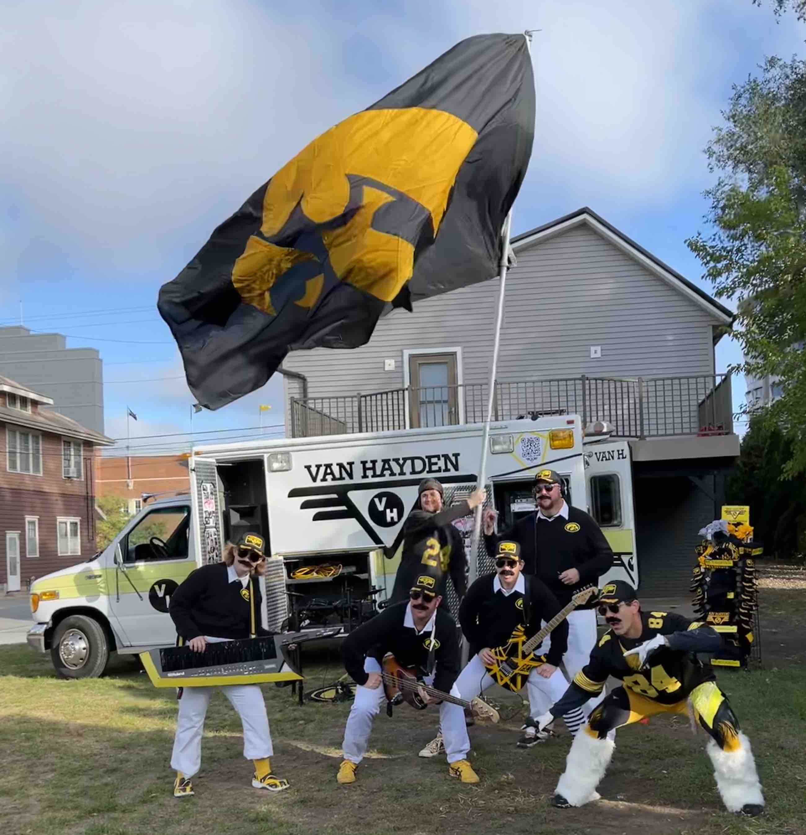 Van Hayden Band with a large Iowa Hawkeye flag and a person dressed up as Nile Kinnick