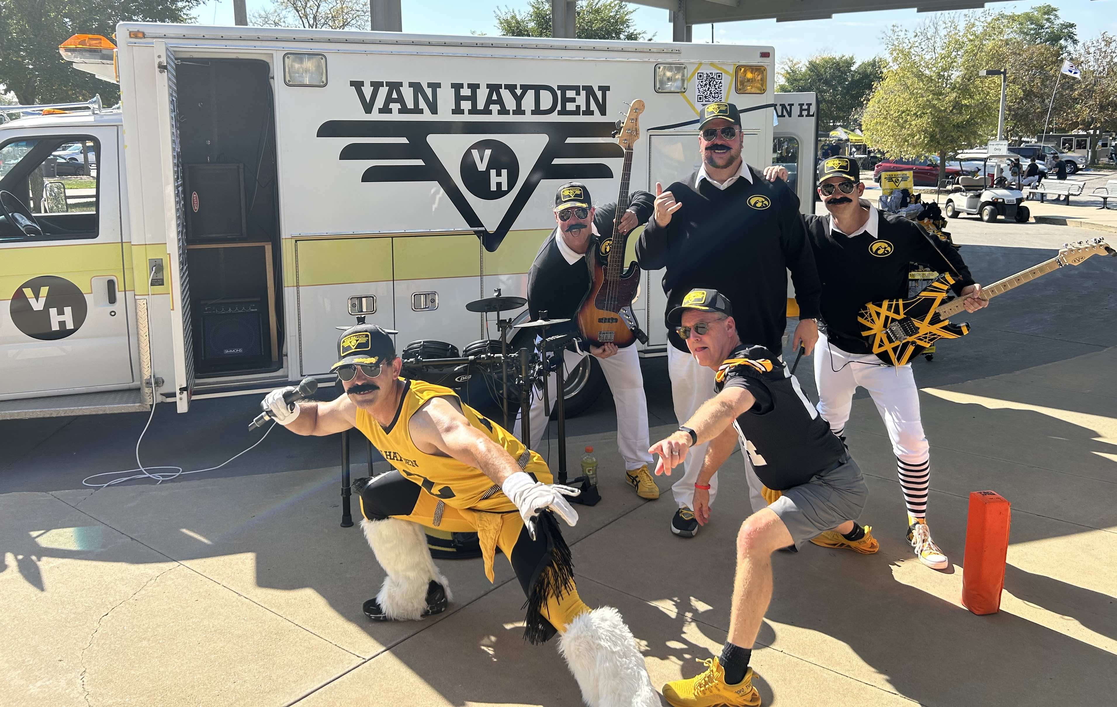 Van Hayden Band posing at the Raecker family tailgate in front of the Vanbulance before the Iowa vs. Michigan State game
