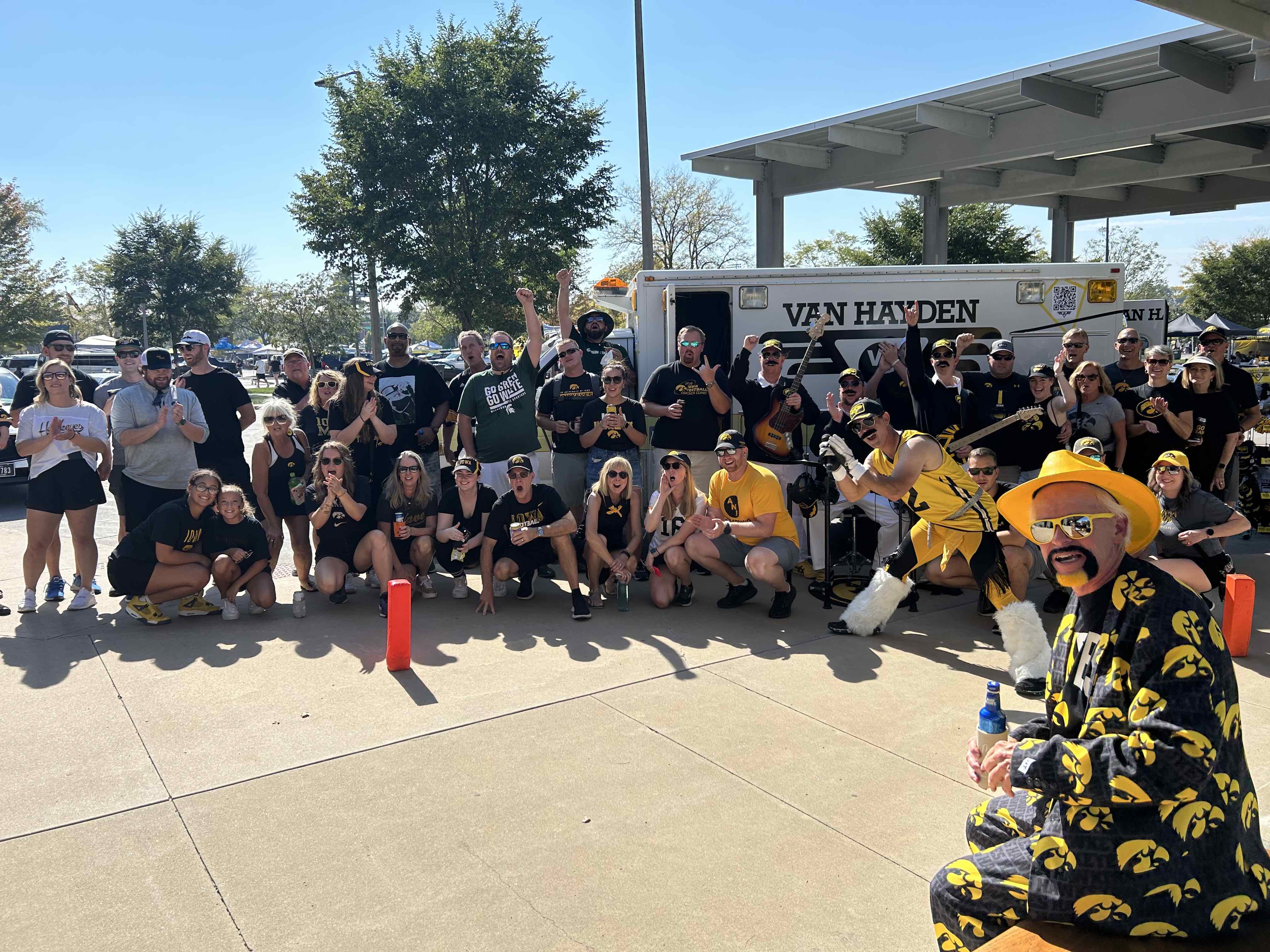 Van Hayden Band posing at the Raecker family tailgate in front of the Vanbulance before the Iowa vs. Michigan State game