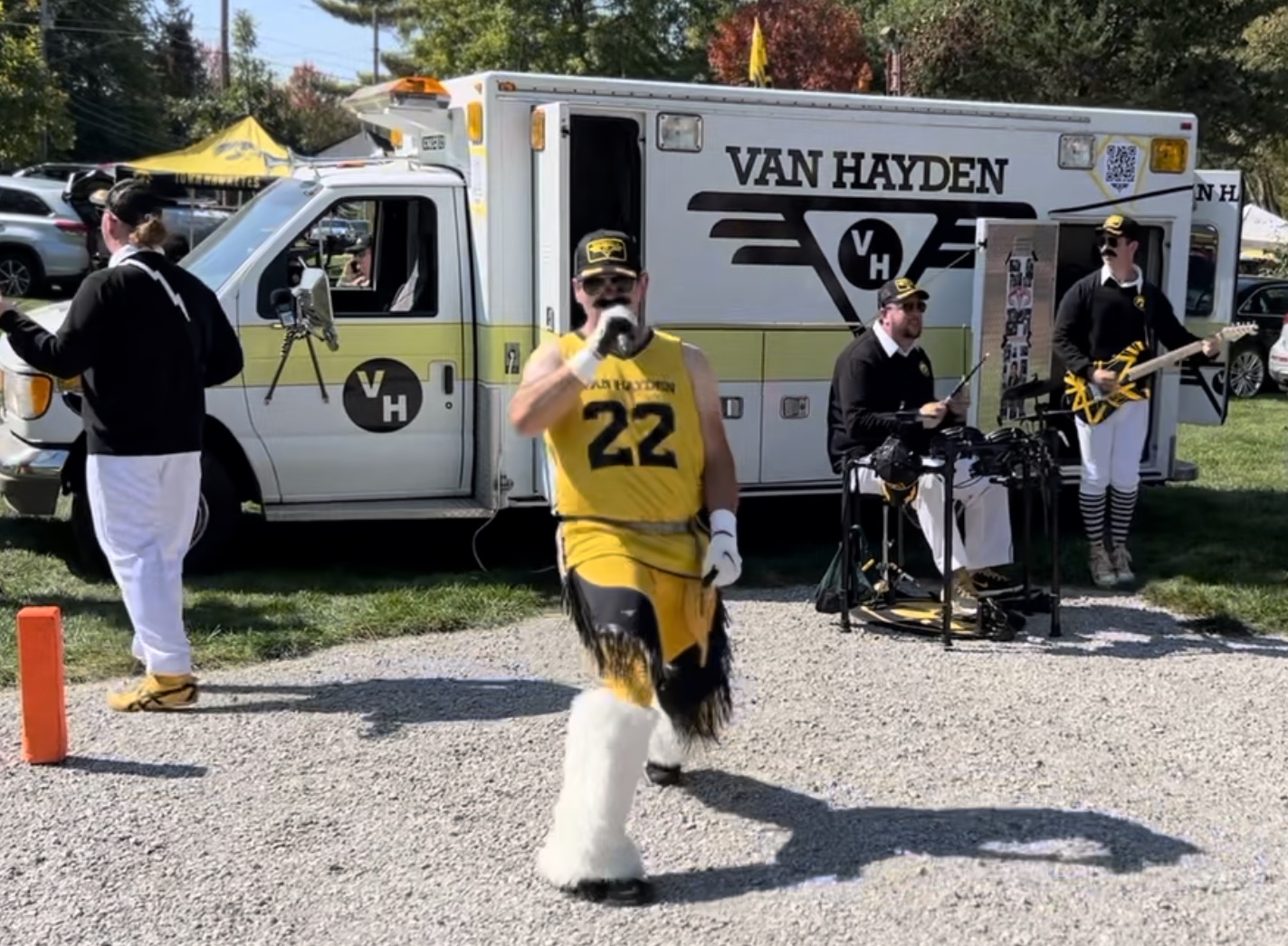 Van Hayden Band performing in front of the Vanbulance at a tailgate for the Iowa vs. Michigan State game