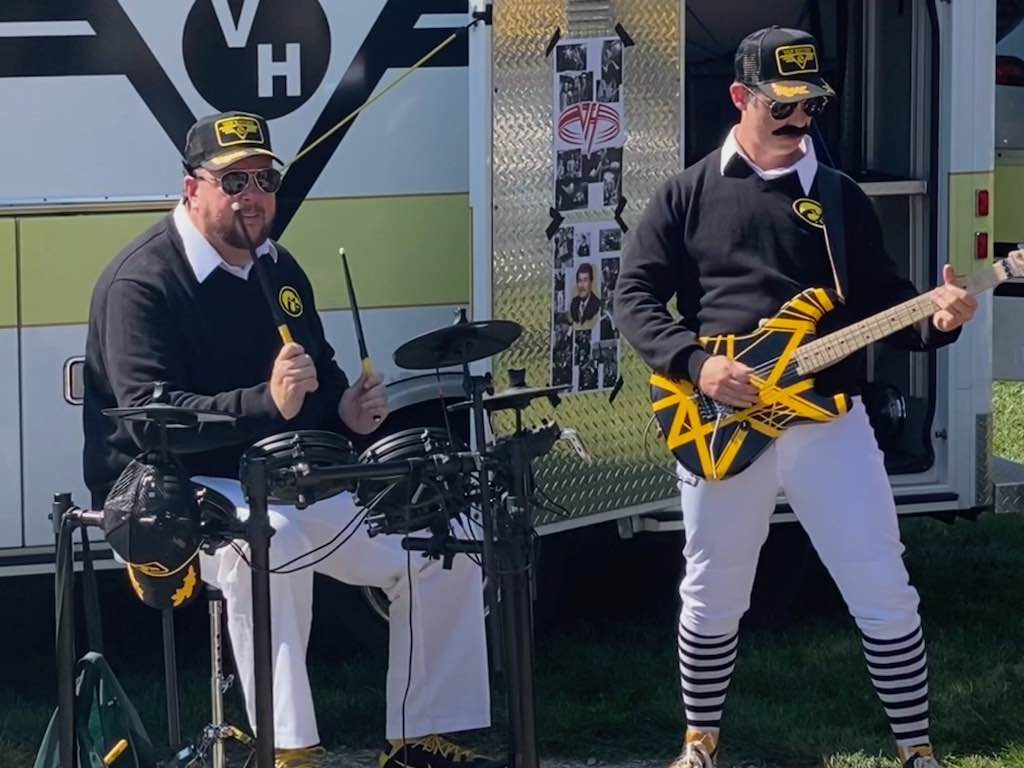 Alex and Eddie Van Hayden performing in front of the Vanbulance at a tailgate for the Iowa vs. Michigan State game